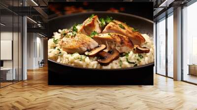 Delicious risotto with grilled chicken fillet and mushrooms on black background Wall mural