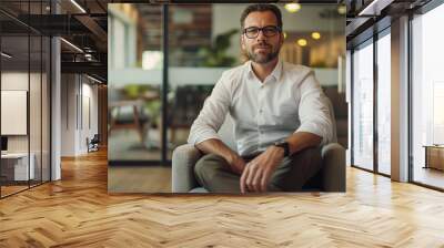 portrait of a businessman sitting at chair in modern office waiting area for a business meeting  Wall mural