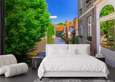 Bakkersrei water canal of Reie river and medieval houses buildings walls with green trees on riverside in Brugge old town quarter district, Bruges city historical centre, Flemish Region, Belgium Wall mural