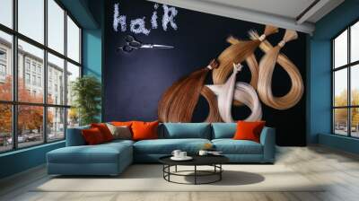 hair extensions of three colors on a dark background. copyspace. top view. Wall mural