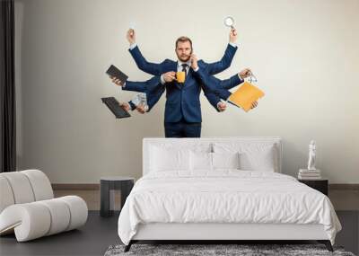 Businessman with many hands in a suit. Works simultaneously with several objects, a mug, a magnifying glass, papers, a contract, a telephone. Multitasking, efficient business worker concept. Wall mural