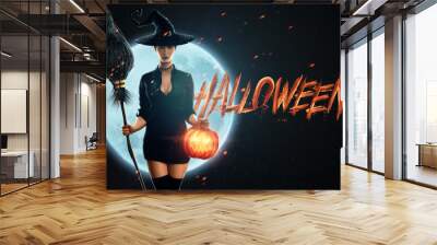 Halloween witch girl with a broom in her hands on the background of the moon. Beautiful young woman in a witch hat conjures. Halloween parties, copy space, Mixed media. Wall mural