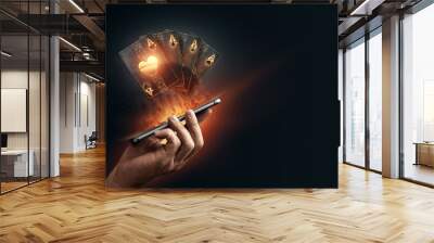 In the hands of a smartphone with playing cards, black-gold background. Concept of online gambling, online casino. Copy space. Wall mural