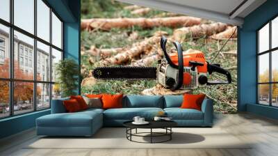 Professional chainsaw close up, logging. Cutting down trees, forest destruction. The concept of industrial destruction of trees, causing harm to the environment. Wall mural