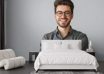 A man with glasses and a beard is smiling and posing for a picture Wall mural