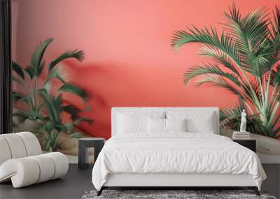 a pink wall with two palm trees in the sand Wall mural