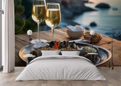 a plate of seafood and two glasses of wine on a table Wall mural