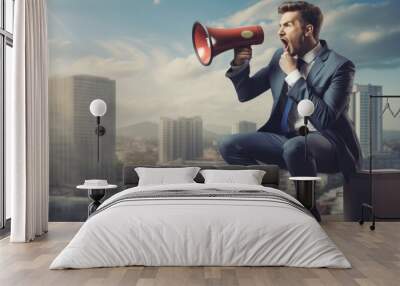 Young super hero business man standing on a chair screaming in megaphone spreading new ideas Wall mural