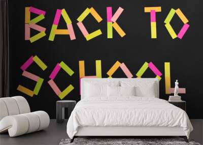 The inscription Back to school from the colored stickers on the blackboard. Wall mural