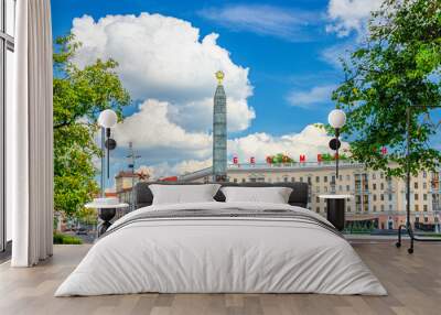 Victory Square in Minsk city centre with Granite Monument of Victory and red letters on the building read 