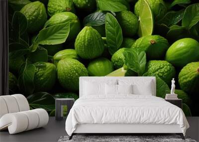 Cut and whole fresh green figs and limes with leaves as background Wall mural