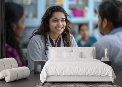 medical team collaboration, indian female doctors collaboratively discussing a patients case in a hospital conference room to offer optimal care by sharing knowledge Wall mural