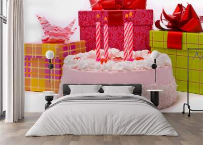 Pink pie with four candles and gifts in boxes on a white backgro Wall mural