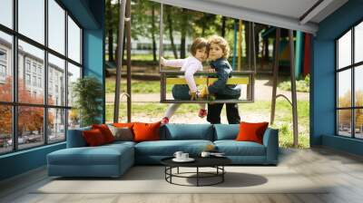 boy and girl on the swings Wall mural