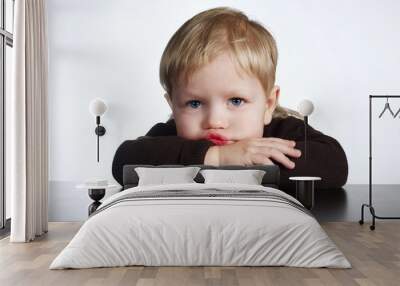 cute little bored boy on white background Wall mural