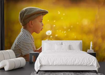 cute little boy with dandelions Wall mural