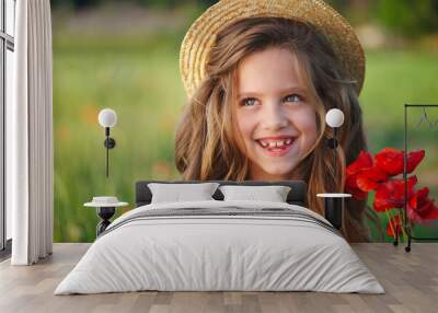 cute little girl in meadow with red poppies Wall mural