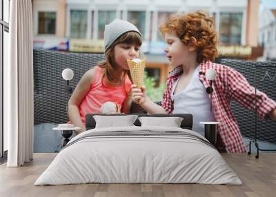 two cute hipsters eating icecream Wall mural