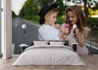 young happy boy and girl together outside Wall mural