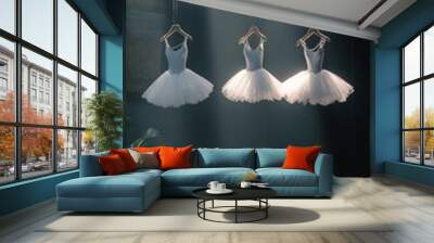 An empty scene featuring a blank mockup template (ballet costumes on delicate hangers in a dim spotlight)  Wall mural