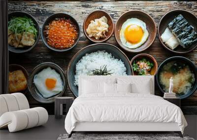   Wooden table topped with bowls of diverse cuisine beside rice and egg atop broccoli Wall mural