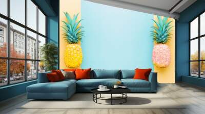 a couple of pineapples sitting next to each other on top of a blue and yellow wall next to each other. Wall mural