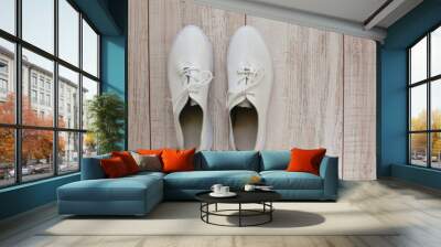 A pair of white sport shoes or sneakers with space for text or design. New white sneakers. The view from the top or flat position. Wall mural