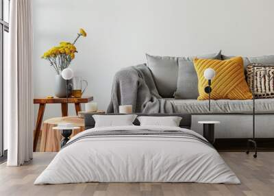 A living room with a couch, coffee table, and potted plants Wall mural