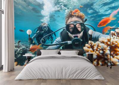 Scuba diver take a selfie explores a vibrant coral reef teeming with fish in the clear blue tropical sea Wall mural