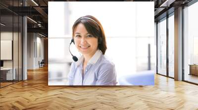 Asian Business woman talking using her headset in the office Wall mural