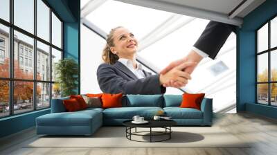 Business man and woman handshake at office Wall mural