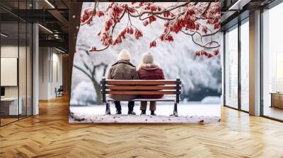 Senior couple sitting on garden bench in autumn with falling snow. Tenderness and complicity. AI generated Wall mural