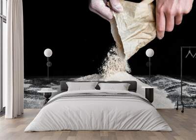 Baker pouring flour on kitchen table. Preparing dough for bread or pizza. Wall mural