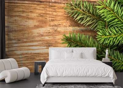 Christmas tree twigs of spruce arranged on aged wooden planks ba Wall mural