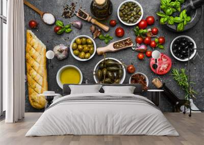 Italian food or mediterranean diet background: herbs, olive, olil, tomato, bread, cheese and wine bottle Wall mural