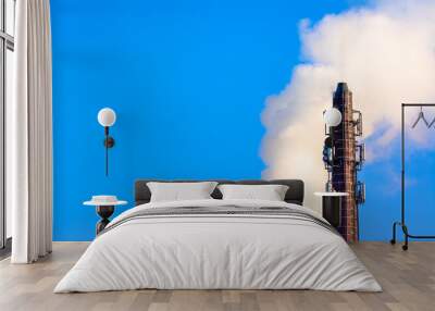 Power plant smokestack with carbon emission - co2, dioxide or fossil fuel. Air pollution by industry. Chimney and smoke cloud on blue sky background. Wall mural