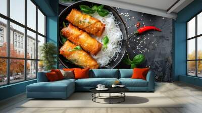 Top view of Asian food: Cold rice vermicelli with sauce, paired with fried spring rolls in a bowl  Wall mural