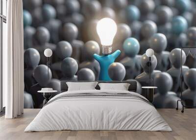 group of identical gray figures, with one figure distinctly colored in blue, standing out as it reaches upwards, holding a brightly shining light bulb symbolizing an idea or innovation. Wall mural