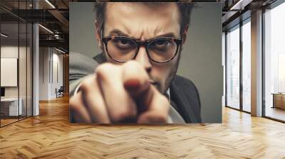 dramatic close-up of a man in glasses pointing directly at the viewer with intense focus and serious expression Wall mural