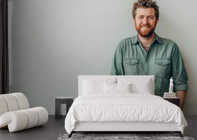 Engaging Portrait of a Confident Man with a Sincere Smile in a Smart-Casual Green Shirt Against a Neutral Backdrop Wall mural