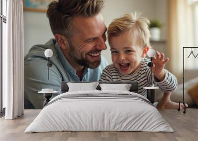 Happy father having fun while playing with his small son at home. Wall mural