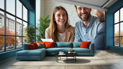 Young happy couple talking with real estate agent and buying a new house, real estate concept Wall mural