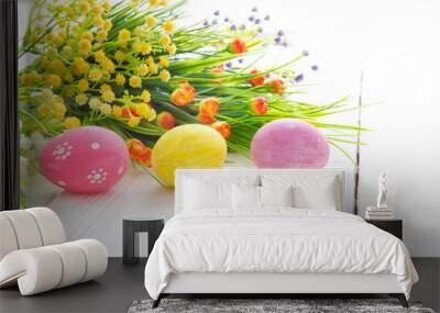 Easter background with decorative Easter eggs and wild flowers. Wall mural