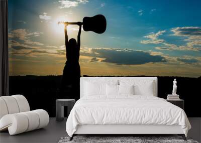 Silhouette woman playing guitar in sunset Wall mural