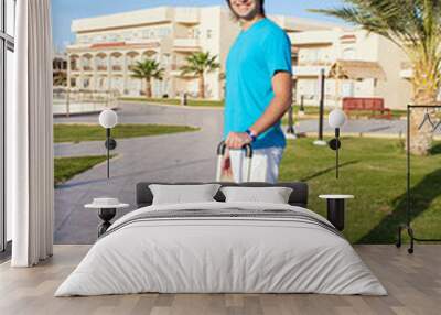 man arriving at Hotel with his luggage Wall mural