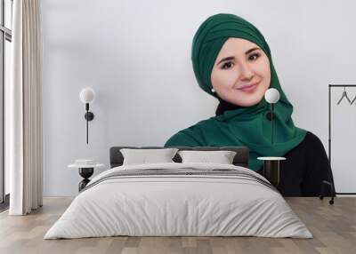 portrait of a happy girl in  green hijab. . Wall mural