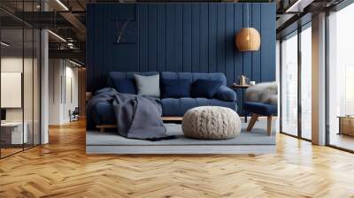 Two knitted poufs near dark blue corner sofa. Scandinavian home interior design of modern living room Wall mural