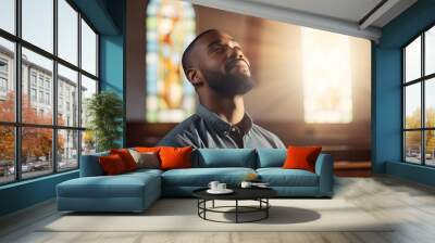 African American man praying in church Wall mural