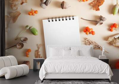 Autumn layout of mountain ash, acorns, fallen leaves, cones with a blank copy space notebook Wall mural