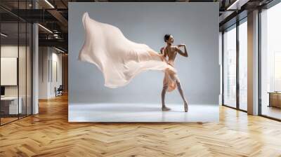 Beautiful ballerina dancing in the body color ballet leotard with body color cloth. She danced on ballet pointe shoes. Wall mural